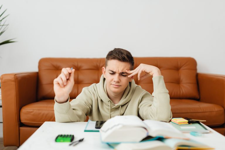 young man struggling to learn
